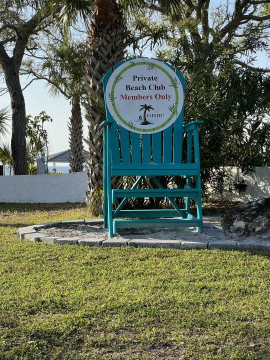 community / neighborhood sign with a yard