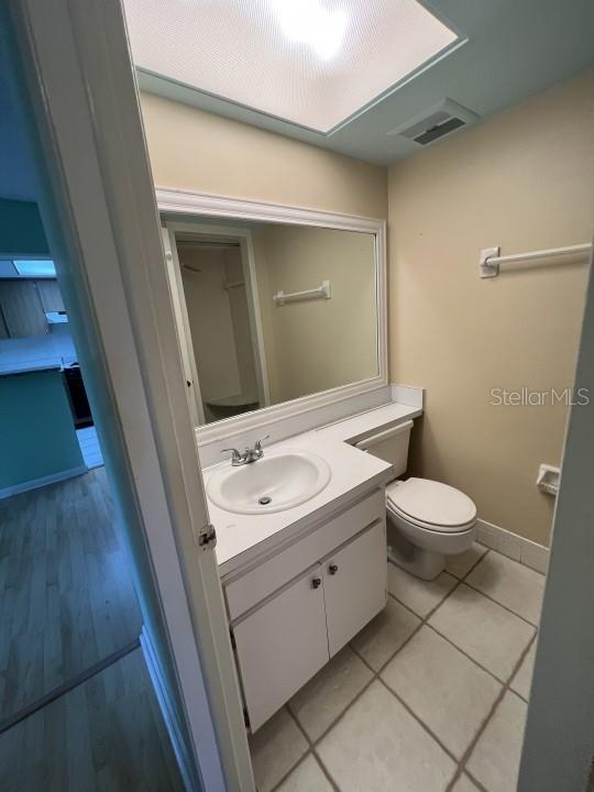 bathroom featuring vanity, toilet, and tile patterned flooring