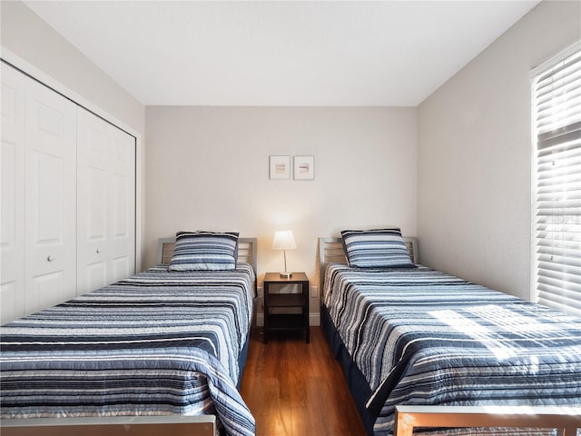 bedroom featuring dark hardwood / wood-style floors and a closet