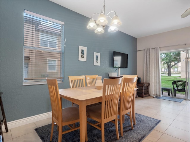 tiled dining space featuring a chandelier