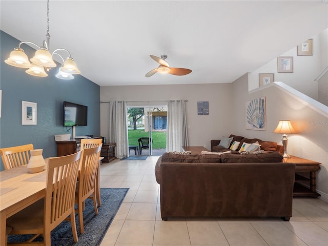 living room featuring light tile patterned floors and ceiling fan with notable chandelier