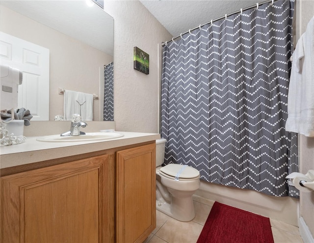 bathroom with tile patterned flooring, vanity, a textured ceiling, curtained shower, and toilet