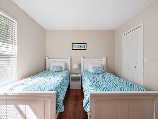 bedroom with a closet and dark hardwood / wood-style floors