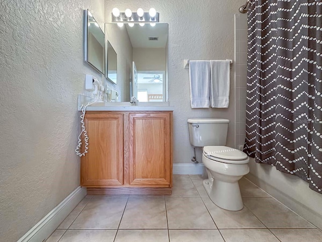 full bathroom featuring shower / bathtub combination with curtain, tile patterned floors, toilet, and vanity