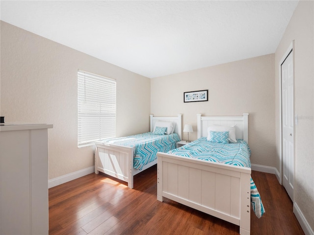 bedroom with dark hardwood / wood-style flooring