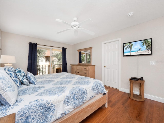 bedroom featuring access to exterior, dark wood-type flooring, and ceiling fan