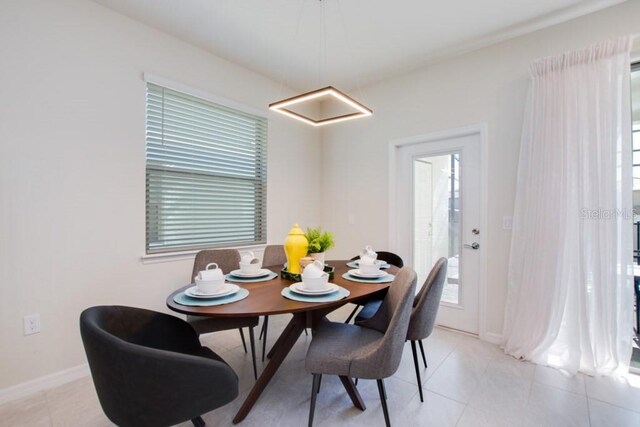 dining area featuring light tile floors