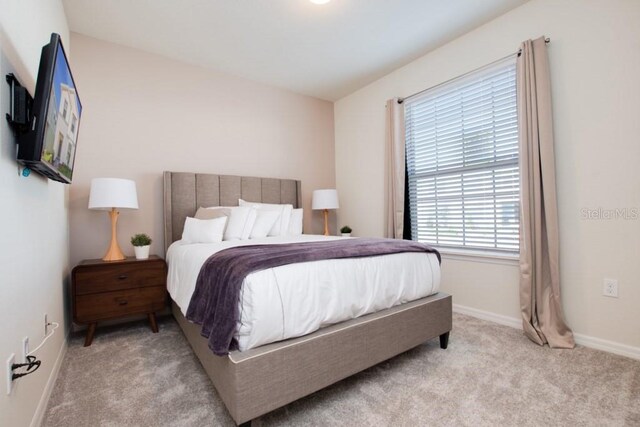 bedroom with light carpet