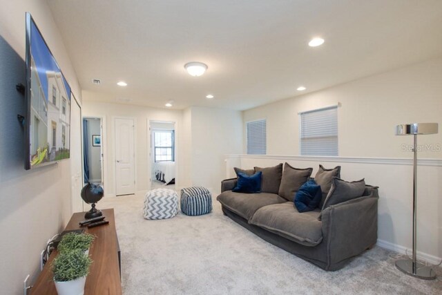 living room featuring light carpet