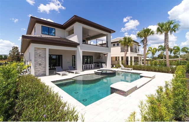 view of pool with a patio, an in ground hot tub, and ceiling fan