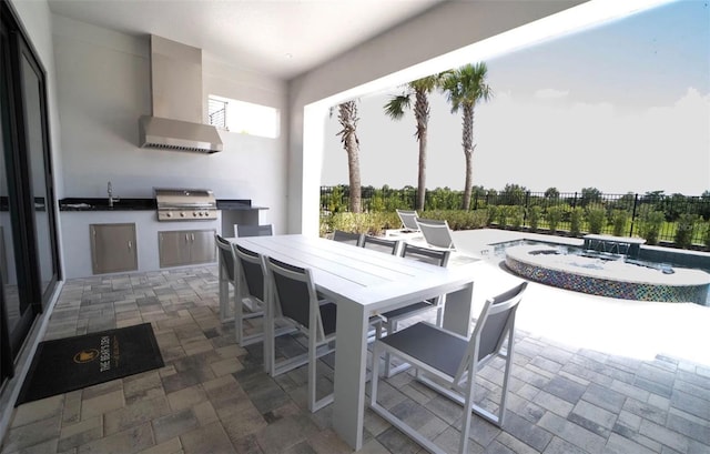 view of patio / terrace featuring a pool with hot tub, an outdoor kitchen, sink, and a grill