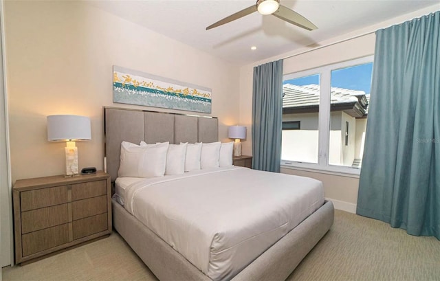 bedroom with ceiling fan and light colored carpet