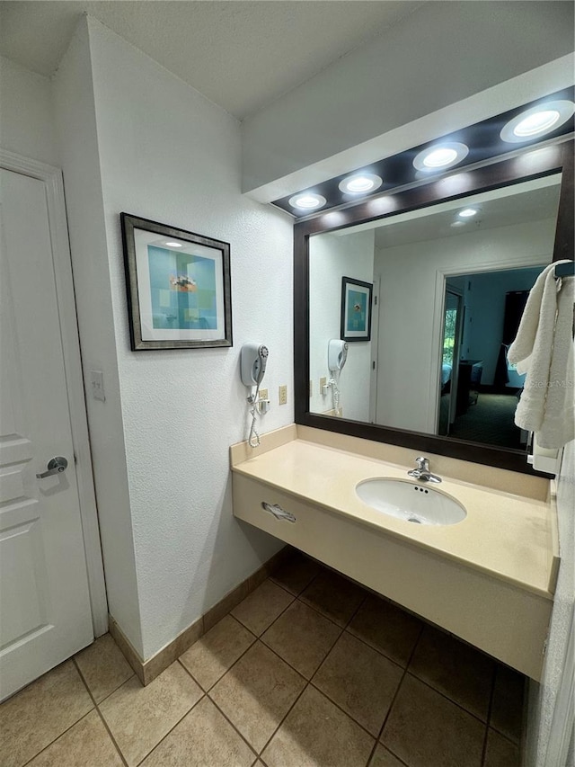 bathroom featuring tile patterned flooring and vanity