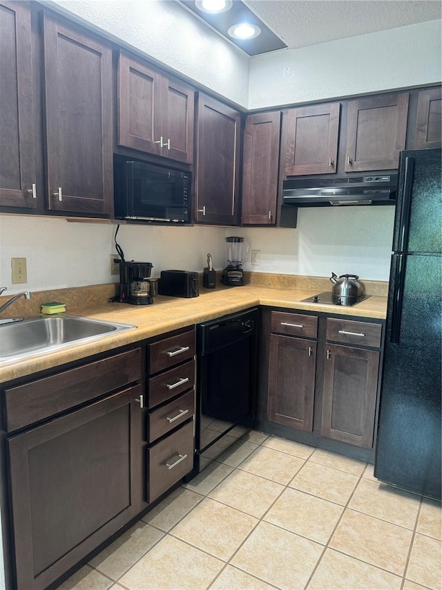 kitchen with dark brown cabinets, black appliances, and light tile patterned flooring