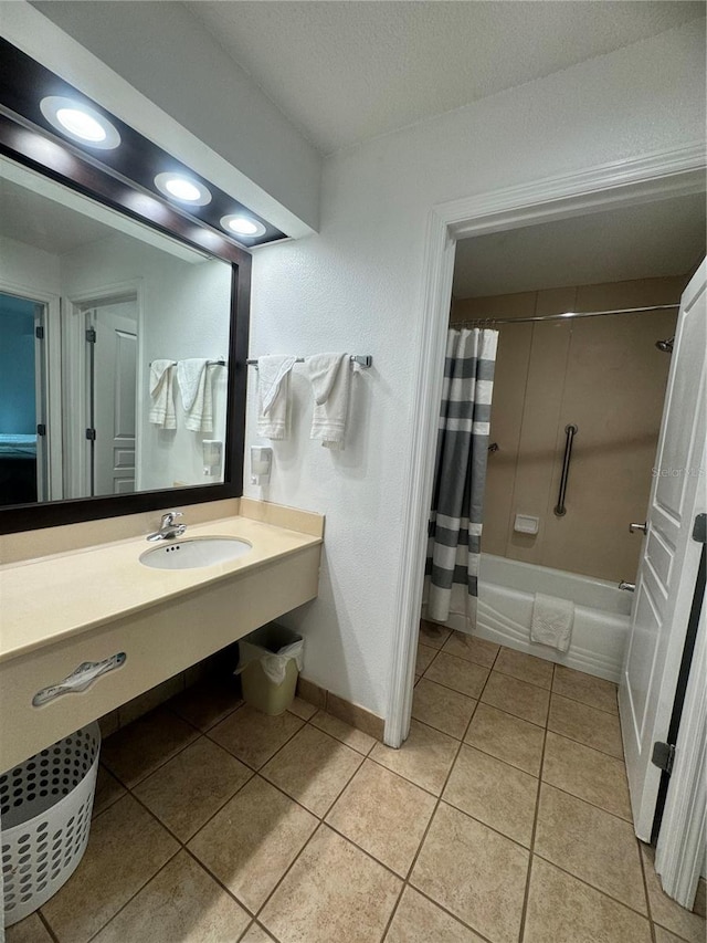 bathroom featuring a textured ceiling, shower / tub combo with curtain, vanity, and tile patterned floors