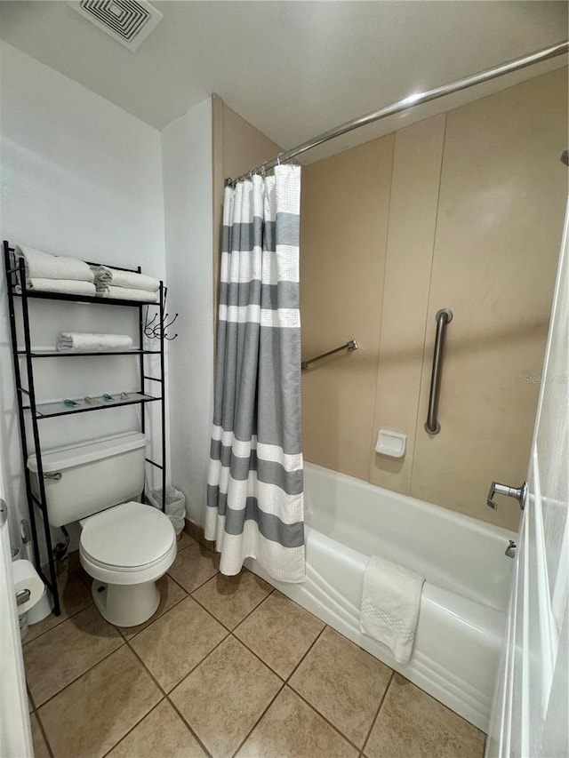 bathroom with shower / bath combo with shower curtain, toilet, and tile patterned floors