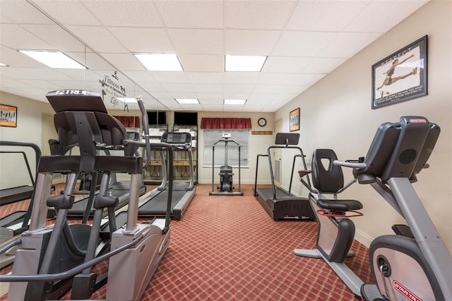 workout area featuring a drop ceiling and carpet flooring