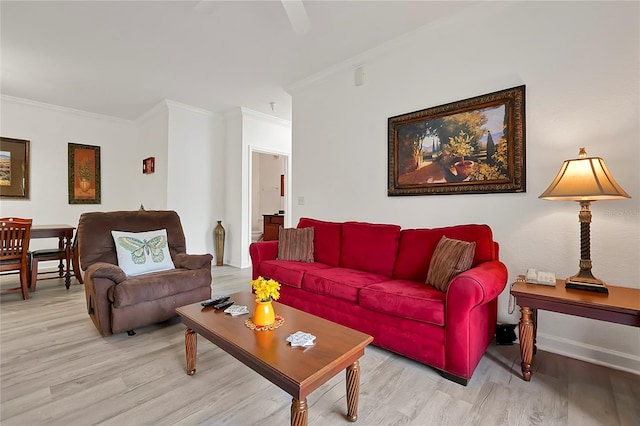 living room with light hardwood / wood-style floors and crown molding