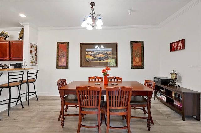 dining space featuring a chandelier, light hardwood / wood-style flooring, and ornamental molding