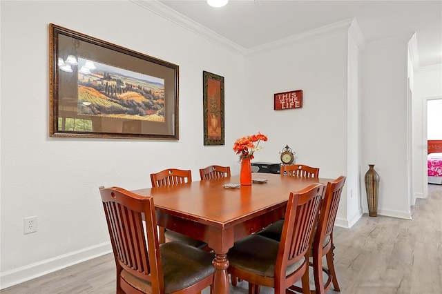 dining room featuring ornamental molding and wood-type flooring