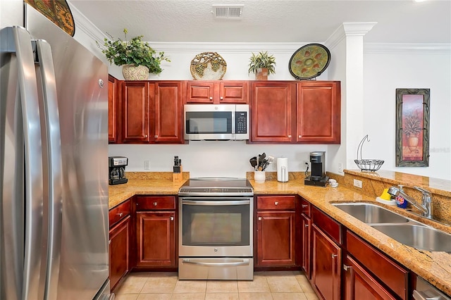 kitchen featuring light stone counters, light tile patterned floors, sink, crown molding, and stainless steel appliances