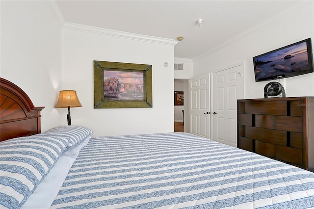 bedroom with a closet, carpet floors, and ornamental molding