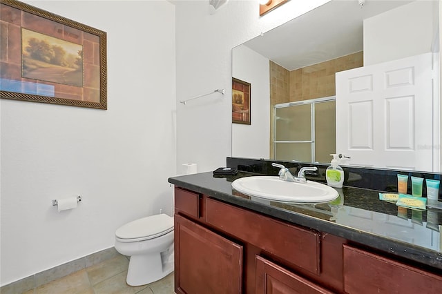 bathroom featuring tile patterned floors, vanity, and toilet