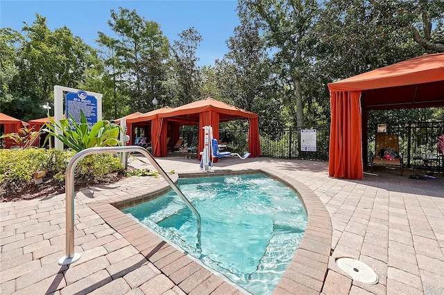 view of swimming pool featuring a gazebo and a patio area