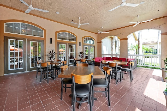 dining room featuring ceiling fan, french doors, tile patterned floors, and a healthy amount of sunlight