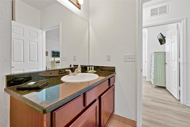 bathroom featuring vanity and hardwood / wood-style floors