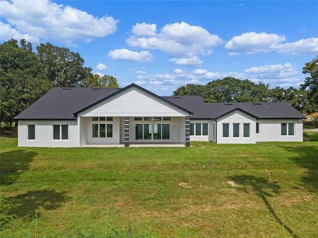 rear view of house featuring a yard and a patio