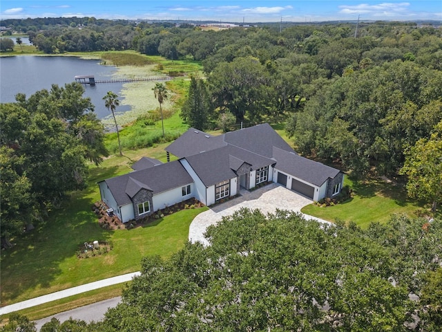 aerial view with a forest view and a water view