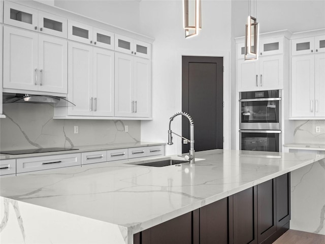 kitchen featuring white cabinetry, sink, double oven, pendant lighting, and black electric cooktop