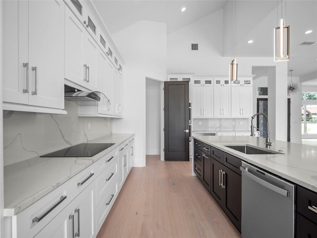 kitchen with dishwasher, black electric stovetop, sink, decorative light fixtures, and white cabinetry