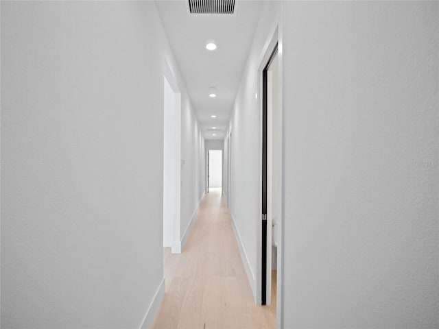 hall with light hardwood / wood-style flooring