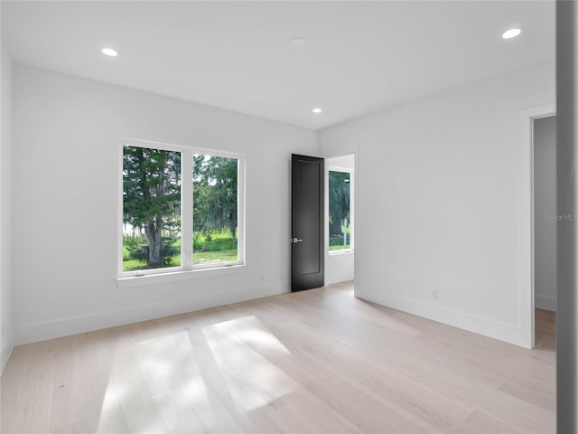 unfurnished room featuring recessed lighting, baseboards, and light wood-style floors