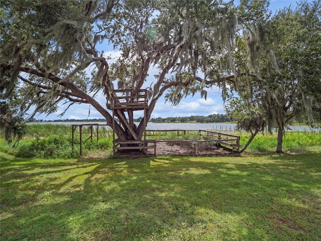 view of yard with a rural view and a water view