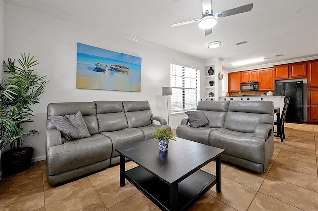 tiled living room featuring ornamental molding, a textured ceiling, and ceiling fan