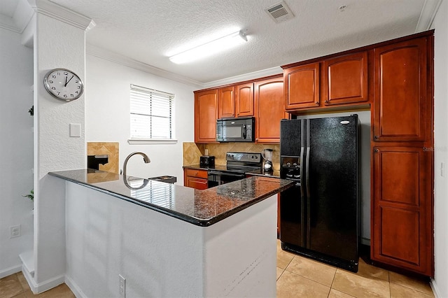 kitchen featuring dark stone countertops, kitchen peninsula, crown molding, and black appliances