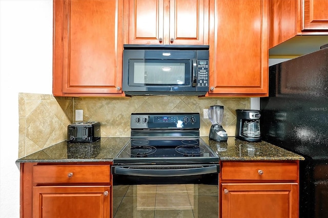 kitchen featuring dark stone countertops, tile patterned flooring, tasteful backsplash, and black appliances