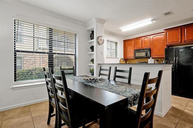 dining room with built in features, ornamental molding, a textured ceiling, and light tile patterned floors