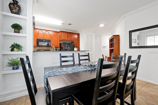 dining area with crown molding, a textured ceiling, and light tile patterned floors