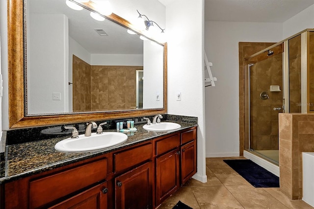 bathroom featuring vanity, tile patterned flooring, and a shower with door