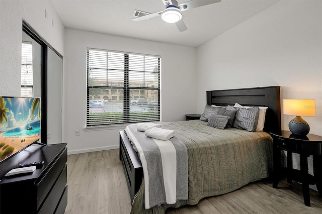 bedroom with ceiling fan and light hardwood / wood-style flooring