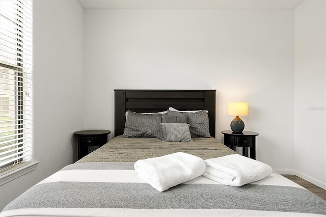 bedroom with dark wood-type flooring