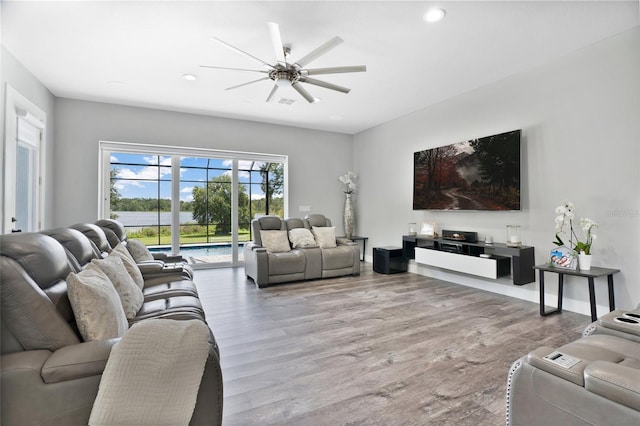 living room with ceiling fan and hardwood / wood-style flooring