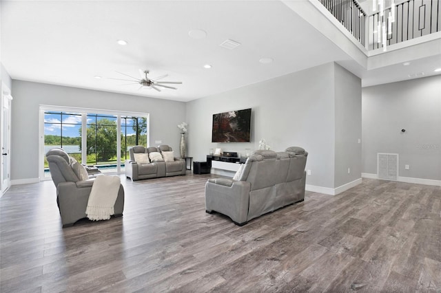 living room featuring ceiling fan and wood-type flooring