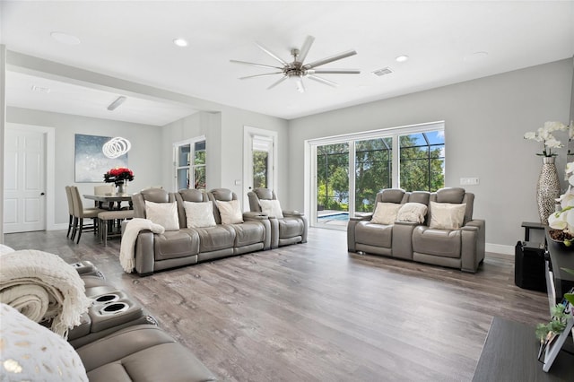 living room featuring ceiling fan and hardwood / wood-style flooring