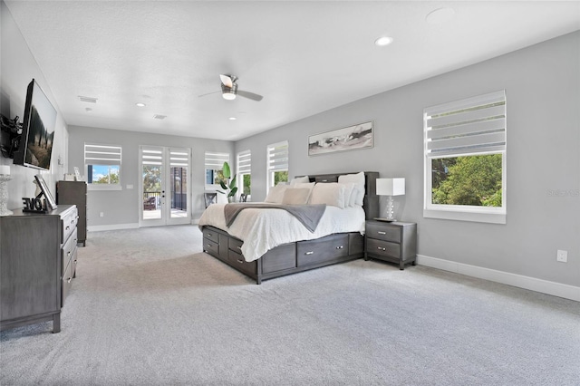 bedroom featuring ceiling fan, access to exterior, french doors, and light carpet