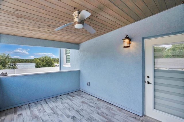 view of patio with ceiling fan and a balcony